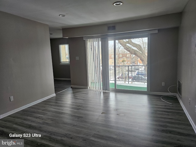 empty room with dark hardwood / wood-style floors