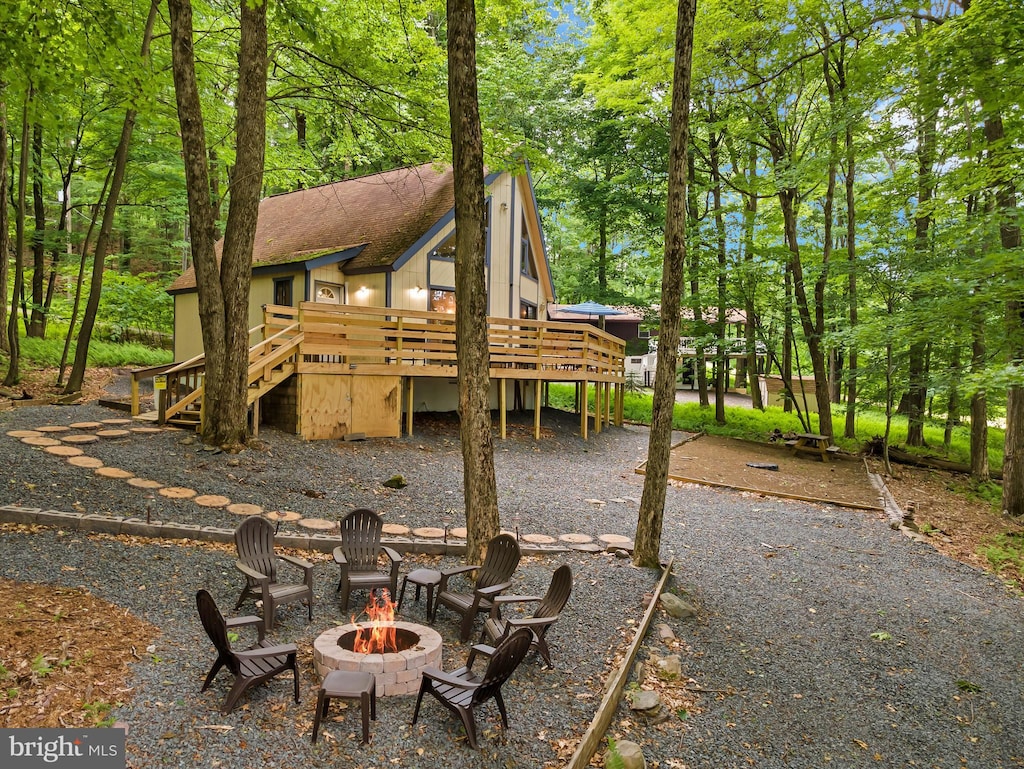 exterior space with a fire pit and a deck