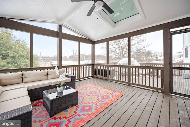 sunroom / solarium with ceiling fan and lofted ceiling with beams