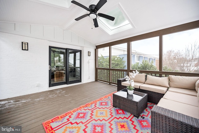 sunroom featuring vaulted ceiling with beams and ceiling fan