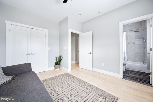 unfurnished bedroom featuring ensuite bathroom, ceiling fan, and wood-type flooring