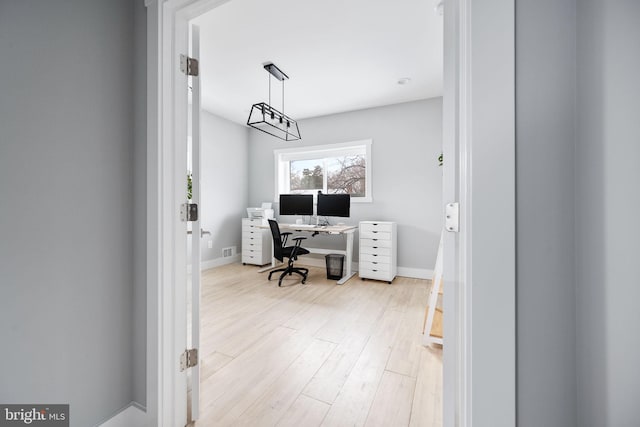 office with light hardwood / wood-style flooring