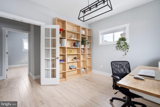 office featuring light wood-type flooring and french doors