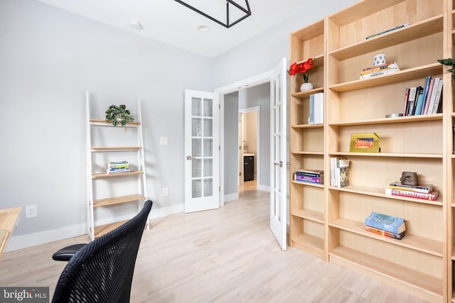 office space with french doors and light hardwood / wood-style floors