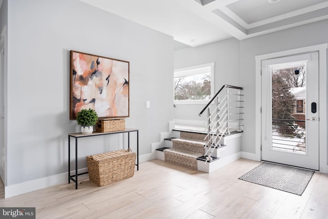 entryway with beamed ceiling, light hardwood / wood-style flooring, and coffered ceiling