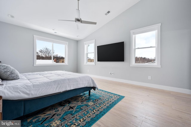 bedroom with ceiling fan, light wood-type flooring, and lofted ceiling