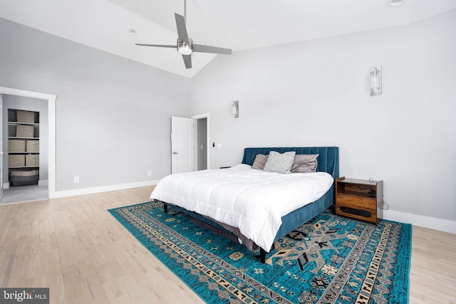 bedroom featuring hardwood / wood-style floors, ceiling fan, and high vaulted ceiling