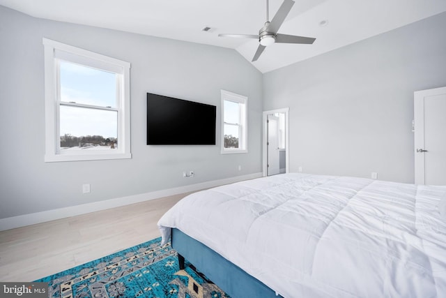 bedroom featuring hardwood / wood-style flooring, ceiling fan, and lofted ceiling