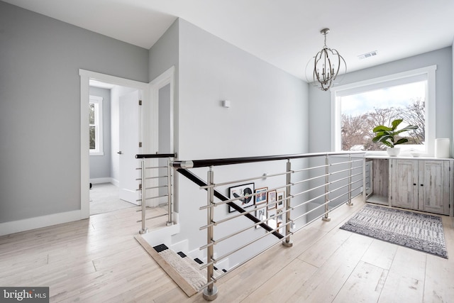 interior space featuring light hardwood / wood-style floors and an inviting chandelier