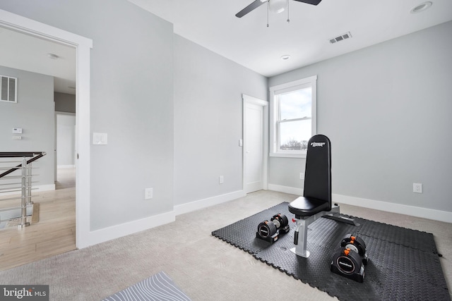 workout area featuring ceiling fan and light carpet