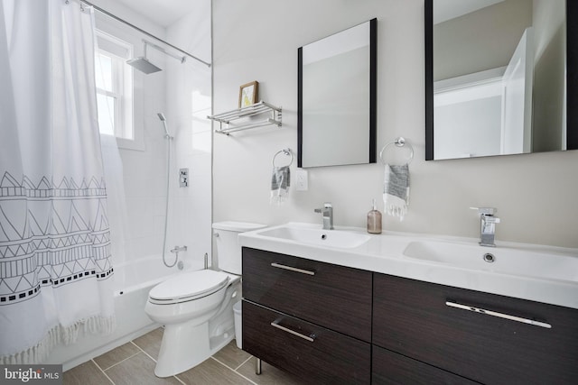 full bathroom with shower / bath combo with shower curtain, vanity, and toilet