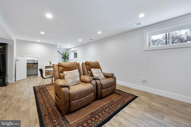 cinema with light hardwood / wood-style flooring