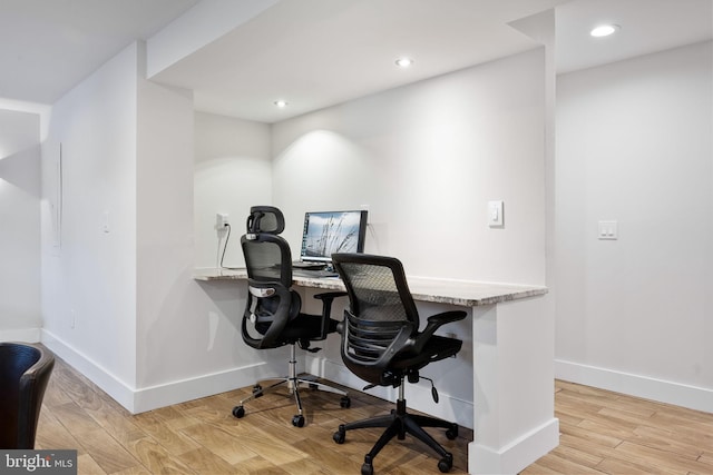 office area with light hardwood / wood-style floors