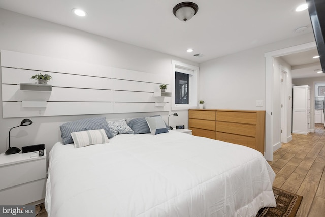 bedroom with wood-type flooring