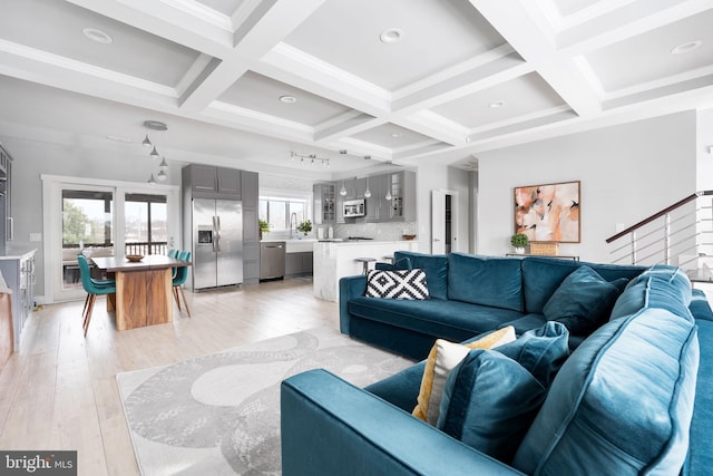 living room featuring beam ceiling, light hardwood / wood-style floors, and coffered ceiling