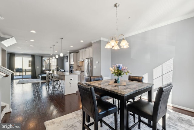 dining area with a chandelier, dark hardwood / wood-style floors, and crown molding