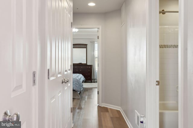 hallway with hardwood / wood-style floors