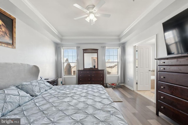 bedroom with light wood-type flooring, ceiling fan, and ornamental molding