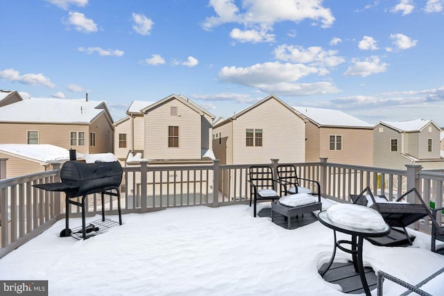 snow covered deck featuring a grill