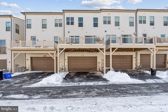 snow covered rear of property featuring cooling unit