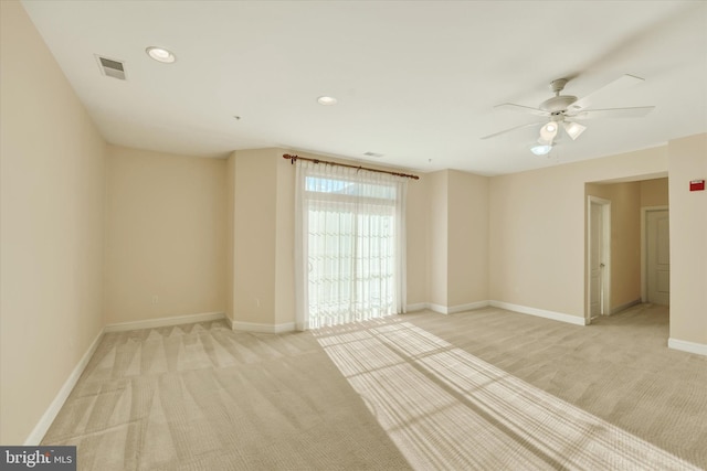 spare room featuring ceiling fan and light colored carpet