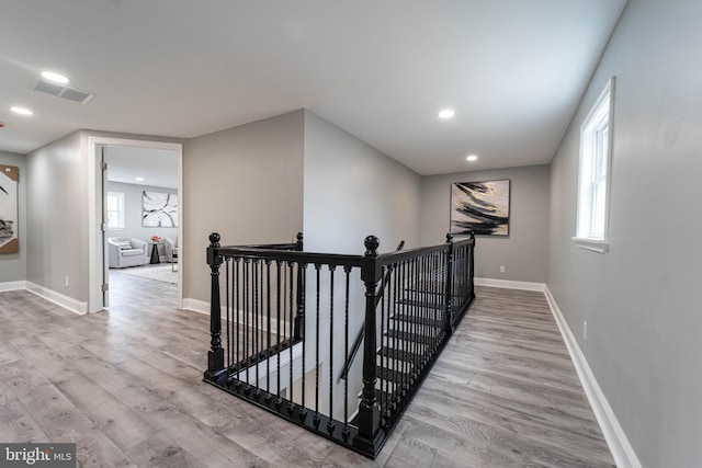 corridor featuring light hardwood / wood-style floors and a wealth of natural light