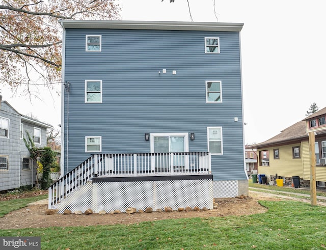 back of property featuring a yard and a deck