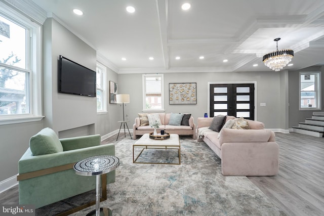 living room with hardwood / wood-style floors, beam ceiling, crown molding, and a chandelier