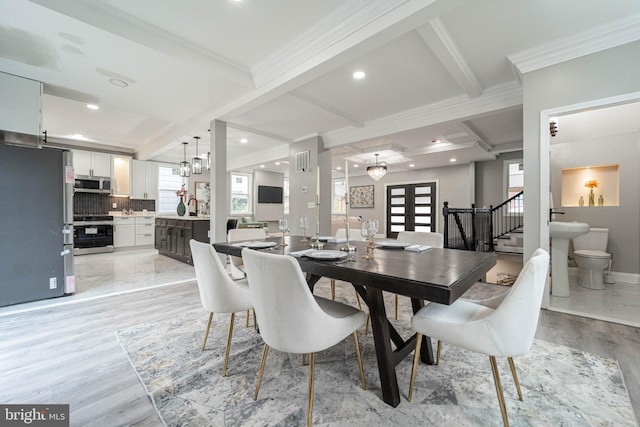 dining room with beamed ceiling, light hardwood / wood-style floors, ornamental molding, and sink