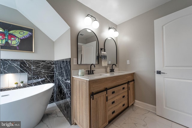 bathroom with vanity, a tub to relax in, tile walls, and lofted ceiling