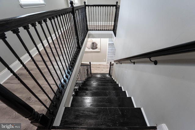 staircase featuring hardwood / wood-style floors