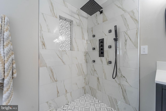 bathroom featuring vanity and tiled shower