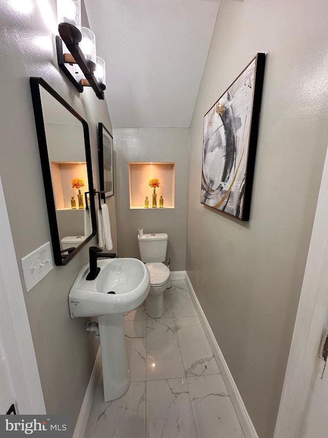 bathroom with vaulted ceiling and toilet