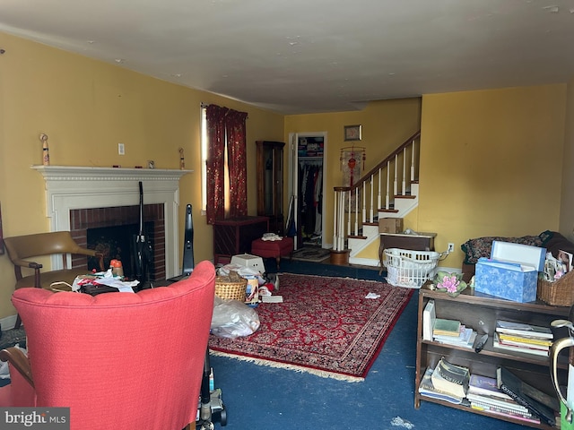 living room with carpet flooring and a fireplace