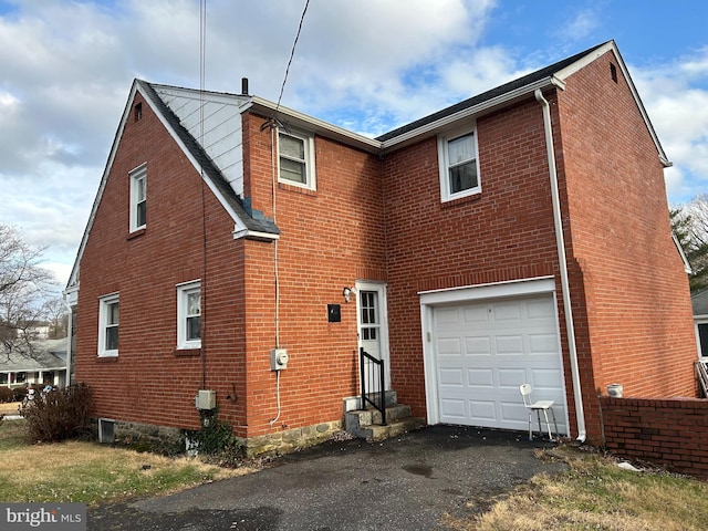 back of property with a garage