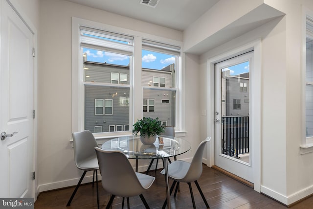 dining space with dark wood-type flooring