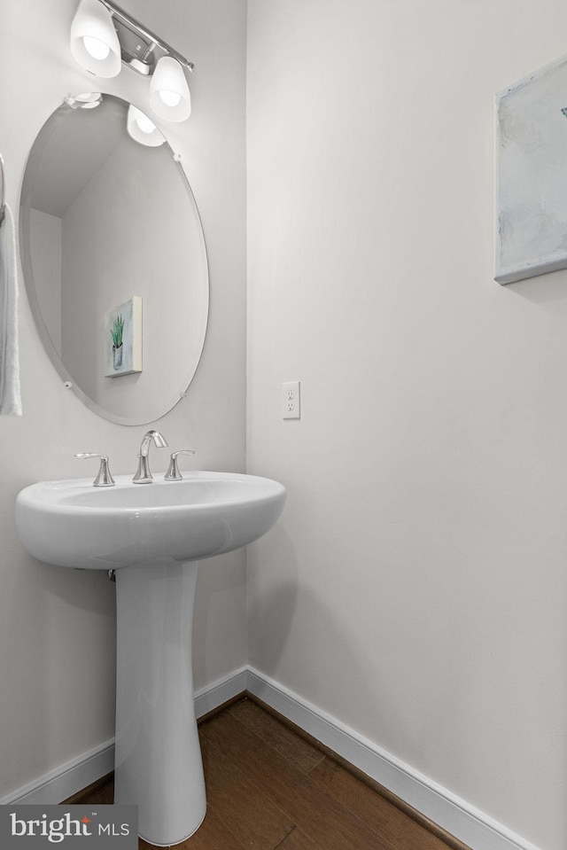 bathroom with wood-type flooring and sink