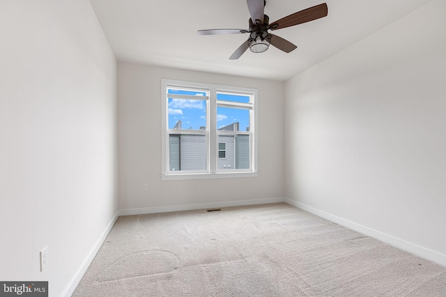 carpeted spare room featuring ceiling fan