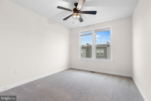 carpeted empty room featuring ceiling fan