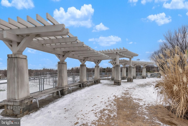 yard covered in snow featuring a pergola