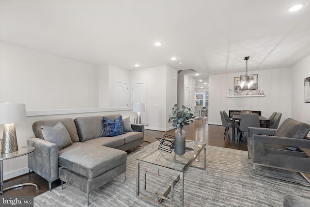 living room with hardwood / wood-style floors and a notable chandelier