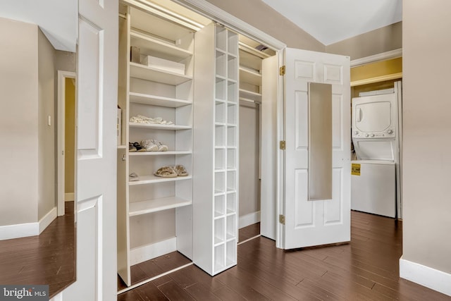 closet with stacked washer and clothes dryer