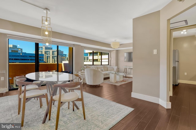 dining space with dark hardwood / wood-style floors