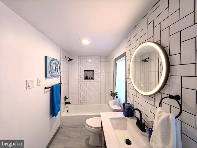 full bathroom with sink, tiled shower / bath, tile walls, and toilet