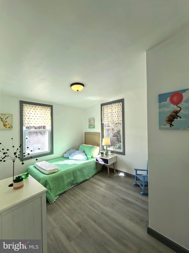 bedroom with dark wood-type flooring