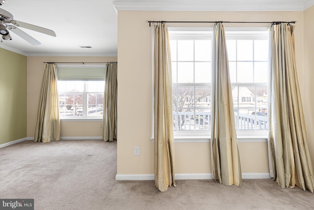 unfurnished room featuring light carpet, ceiling fan, and a healthy amount of sunlight