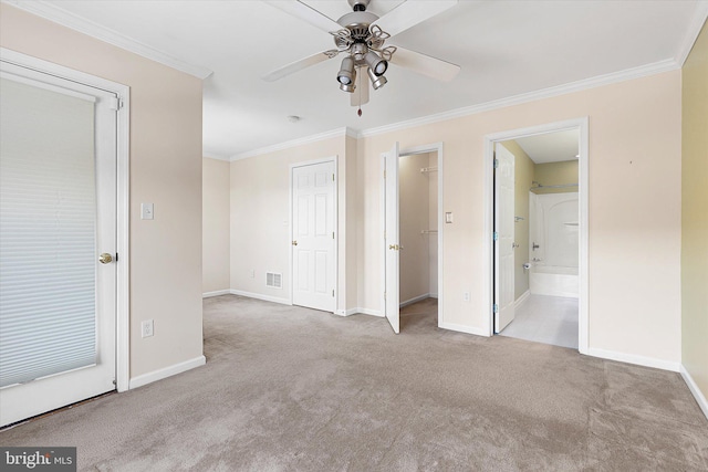 unfurnished bedroom with connected bathroom, ceiling fan, light colored carpet, and ornamental molding