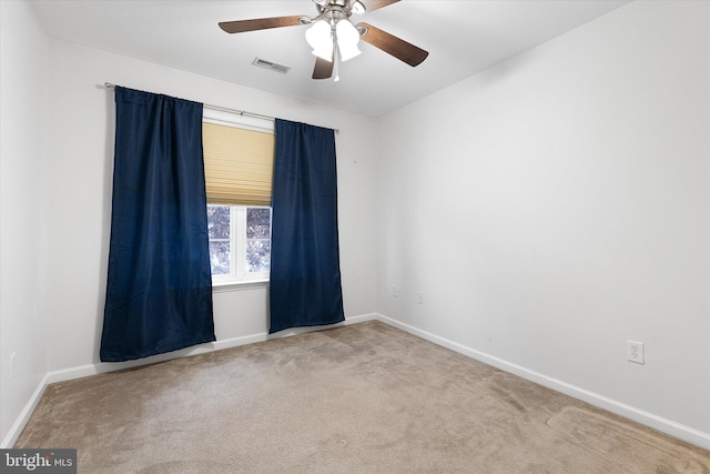 carpeted spare room with ceiling fan