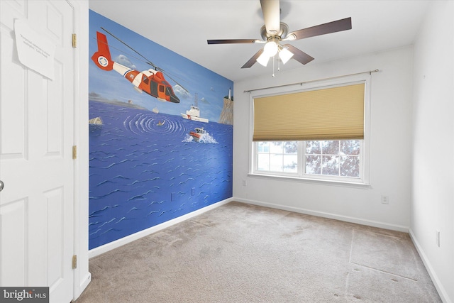 unfurnished room featuring light colored carpet and ceiling fan