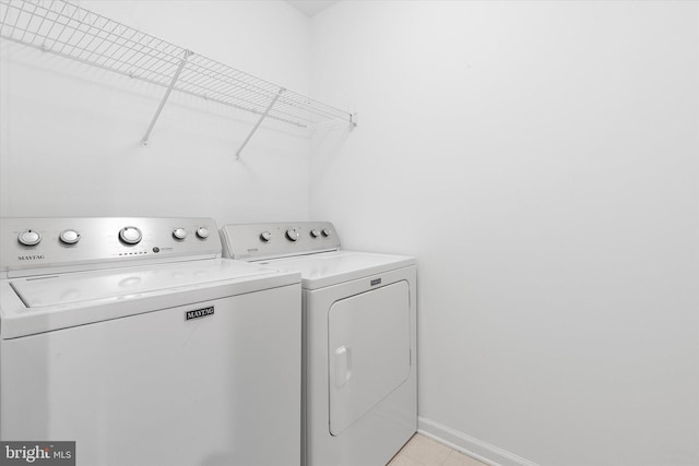 clothes washing area with washer and clothes dryer